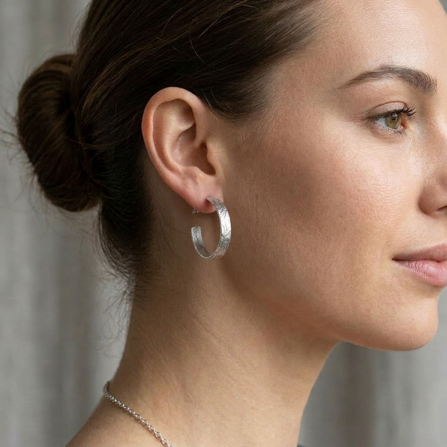 1.25 Inch Diameter Textured Silver Hoop Earrings Minimalist Style lifestyle use image