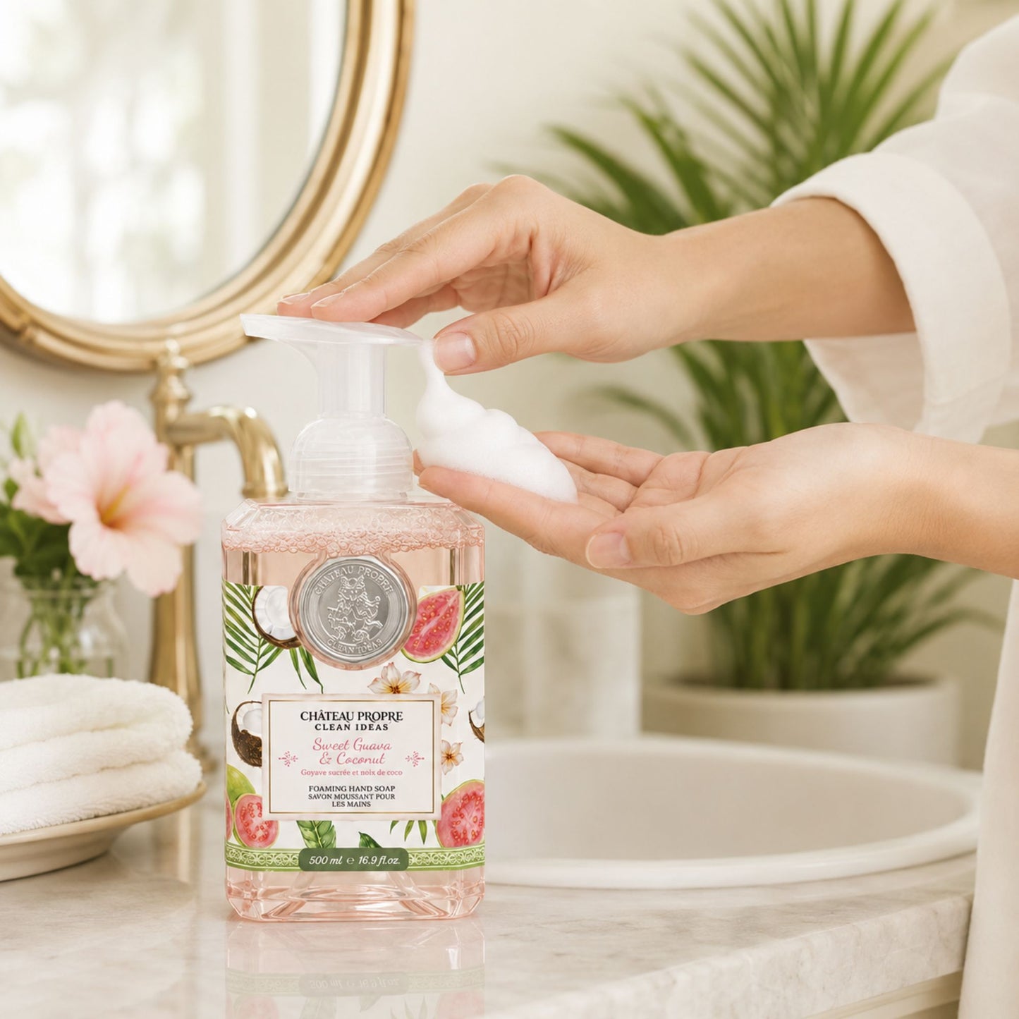Person using a bottle of Chateau Pierre Aupres soap with a floral design in a bathroom setting.
