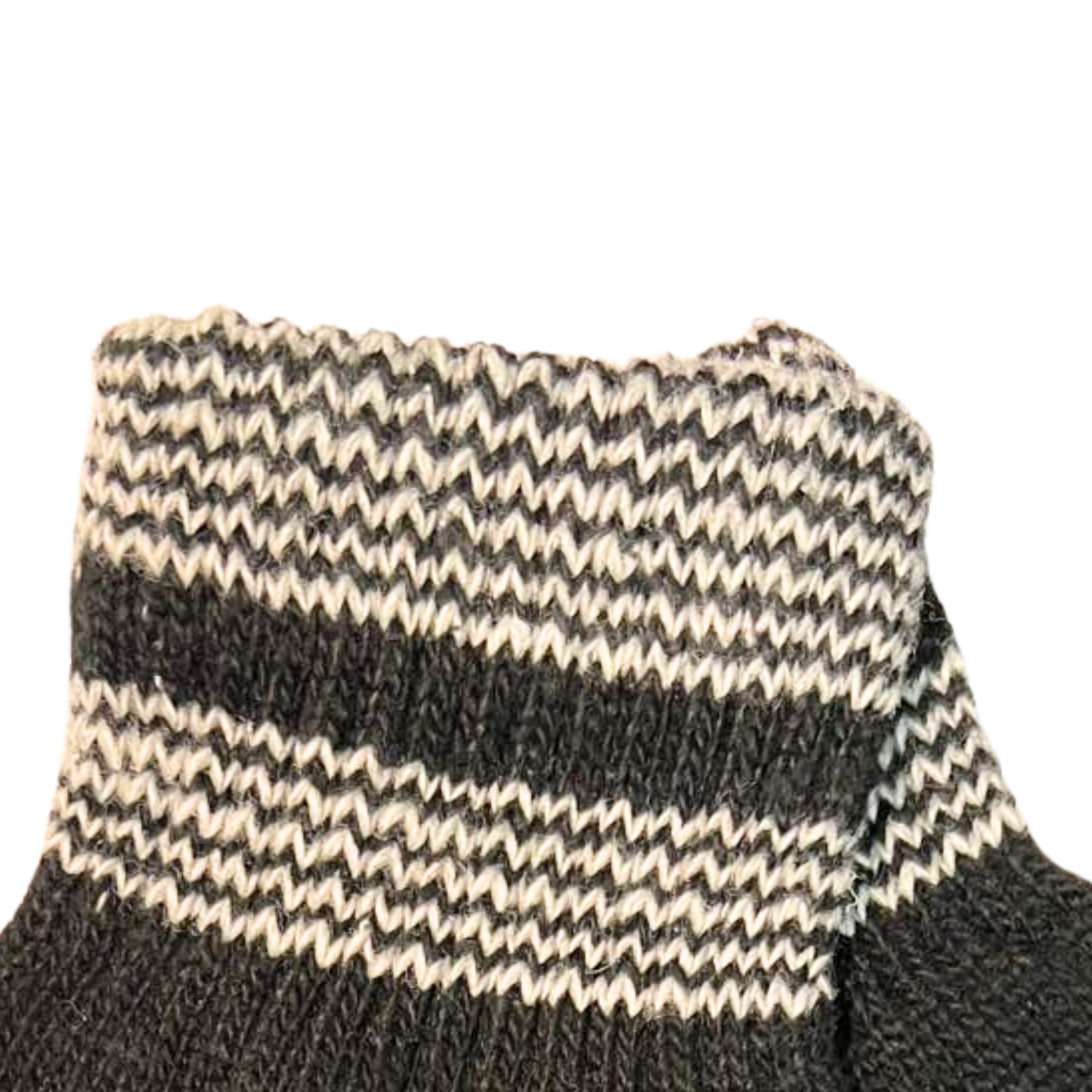 Close-up of a black and beige striped sock on a white background