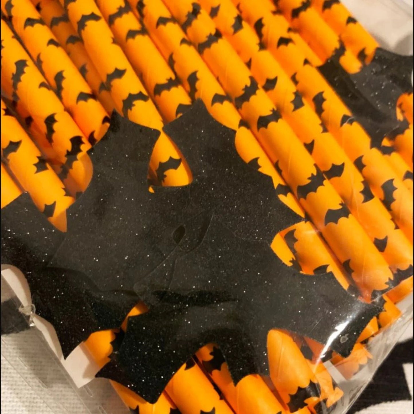 Halloween-themed candy sticks with orange and black colors.