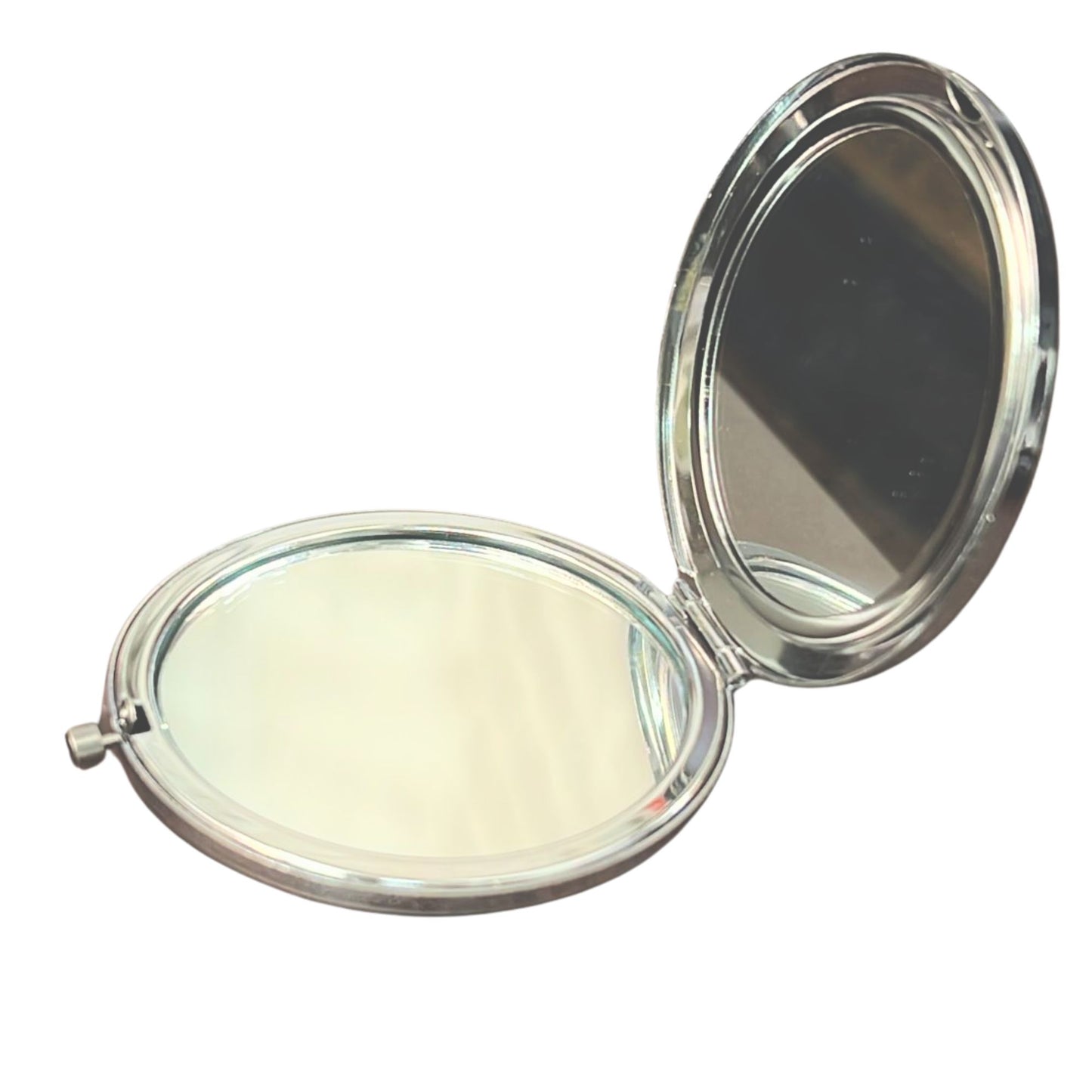 Compact mirror with two reflective surfaces on a white background