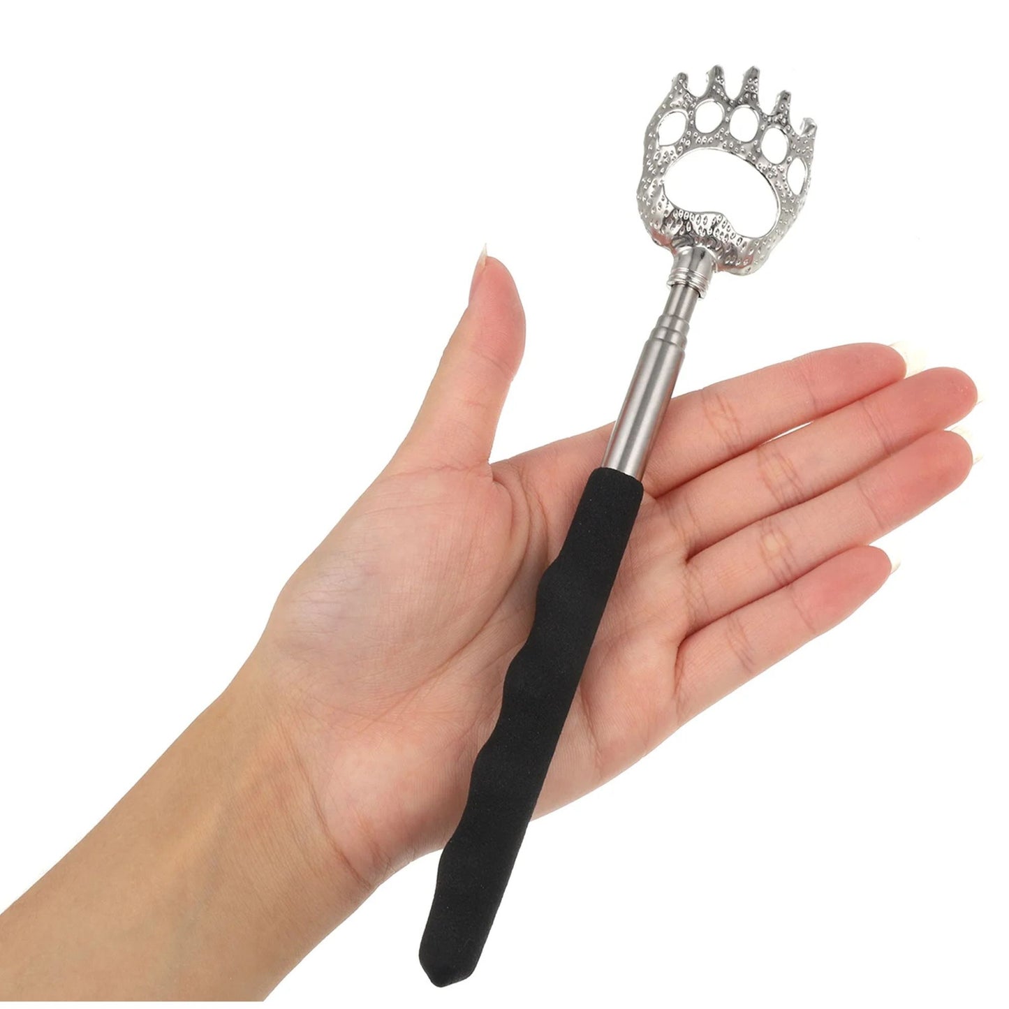 Hand holding a back scratcher with bear paw design on a white background