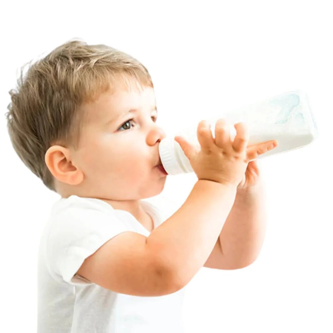 Child drinking from a bottle against a white background