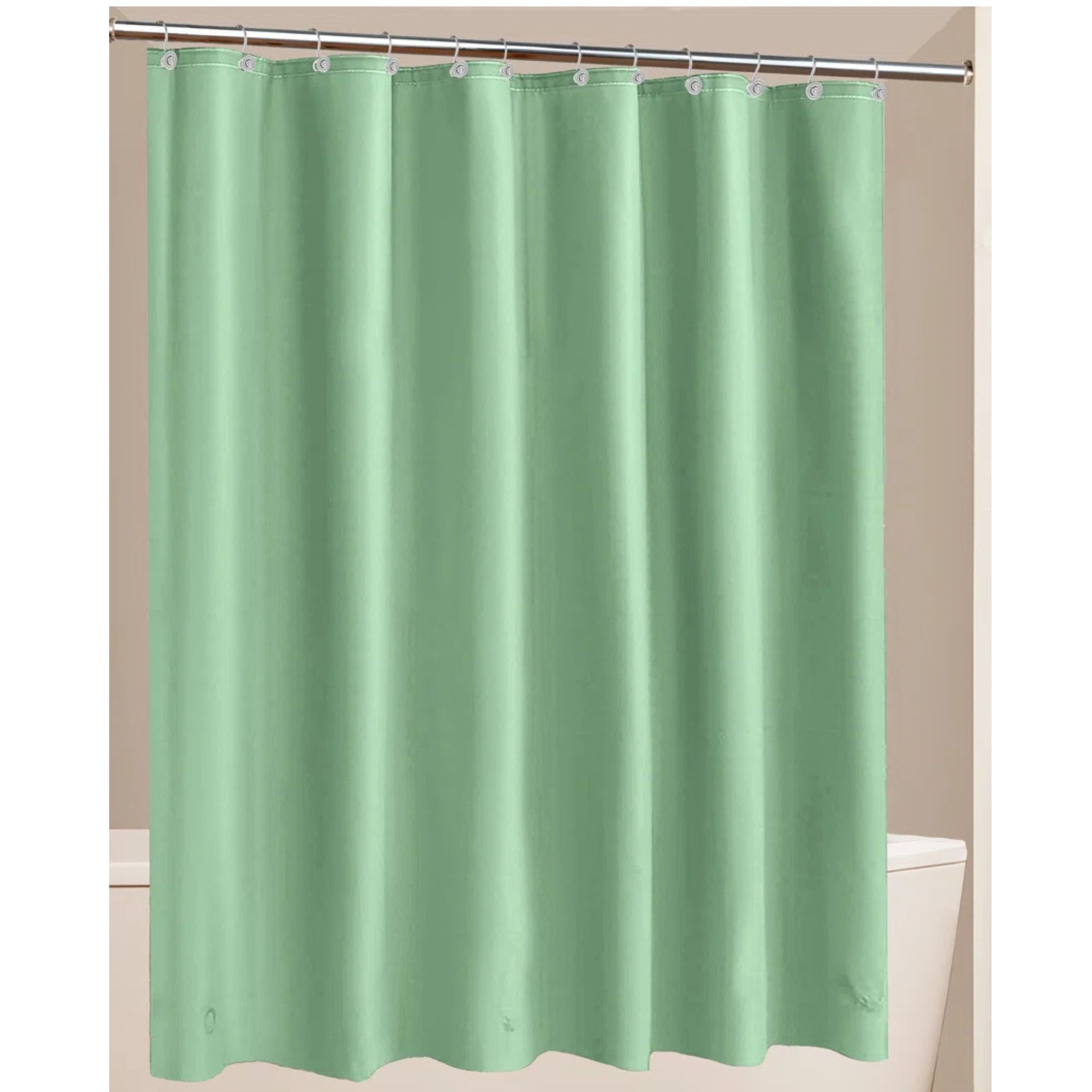Green shower curtain hanging on a rod against a beige wall.