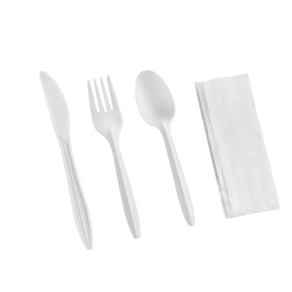 Set of white plastic cutlery and napkin on a white background