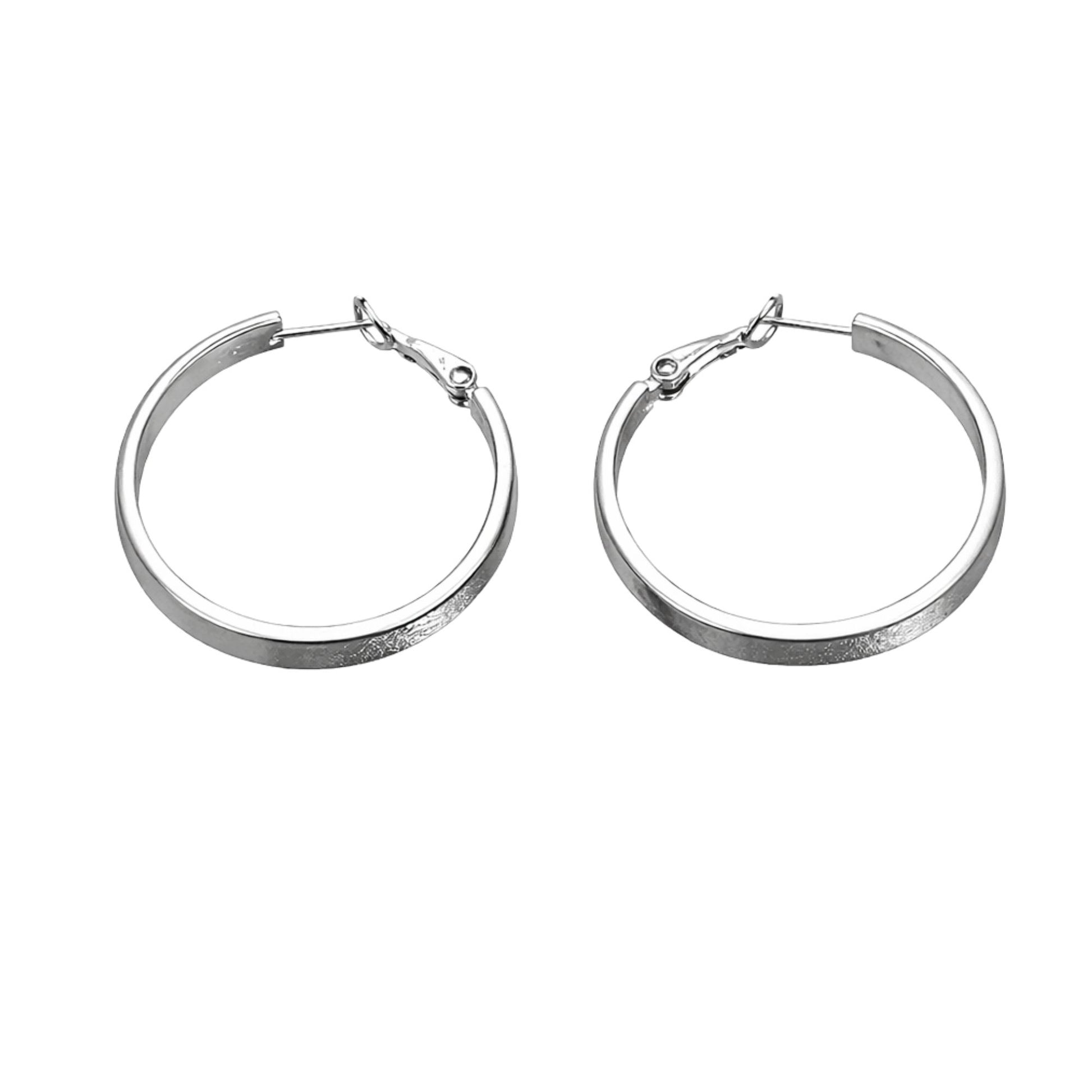 Pair of silver hoop earrings on a white background