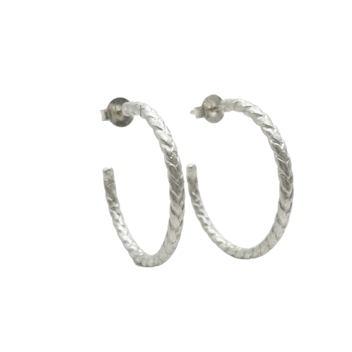 Silver hoop earrings on a white background