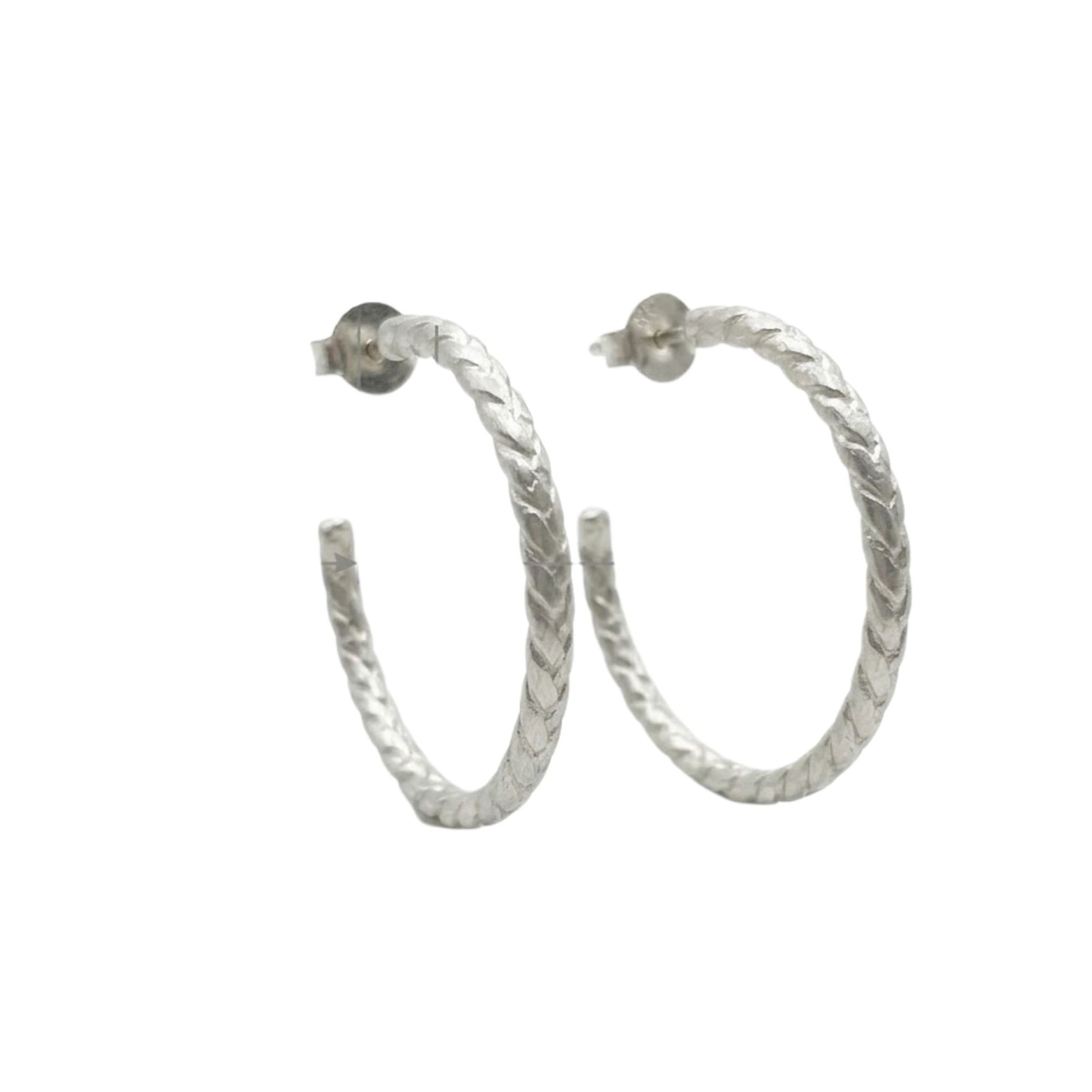 Silver hoop earrings on a white background