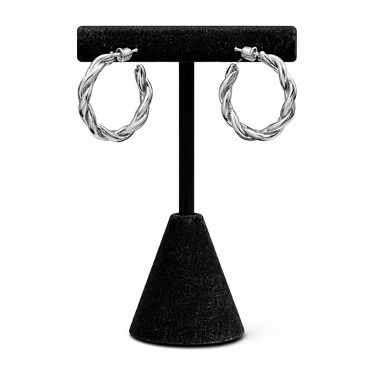Silver hoop earrings on a black earring stand against a white background