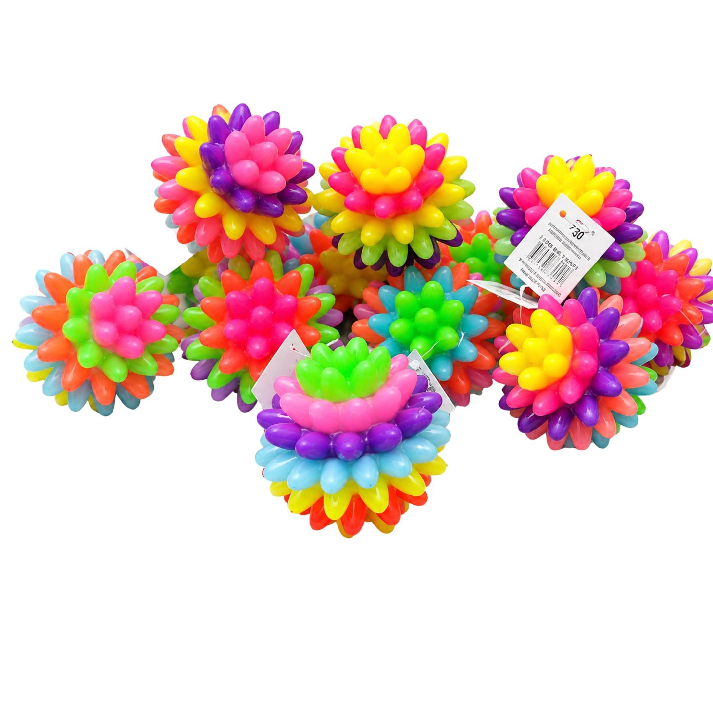 A group of colorful, spiky ball-shaped toys made of textured plastic, arranged on a plain white background. Several of the toys still have their retail tags attached.