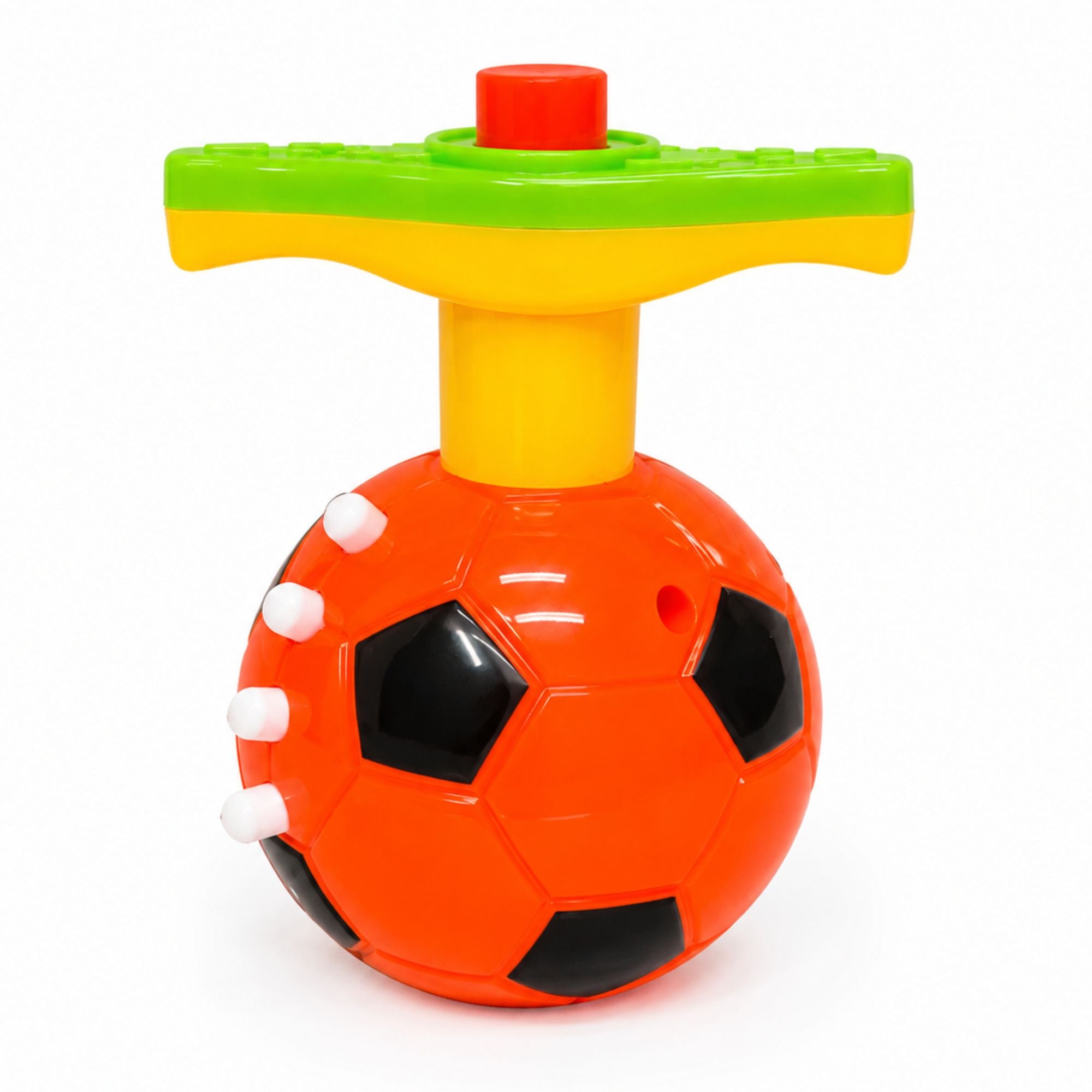 A colorful plastic baby toy rattle shaped like a soccer ball, featuring a bright orange base with black and white panel details, a yellow neck, and a T-shaped handle with green, yellow, and red sections, set against a plain white background.