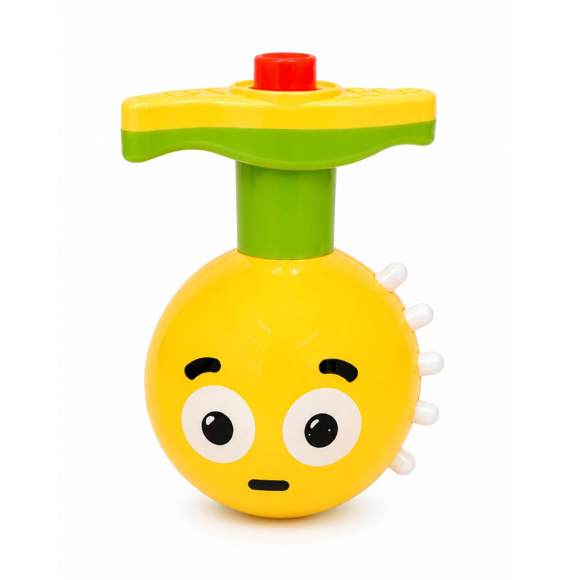 A yellow and green plastic baby toy with a round character head, large cartoon eyes, a small red button on top, and white spiky details on the side, photographed on a plain white background.