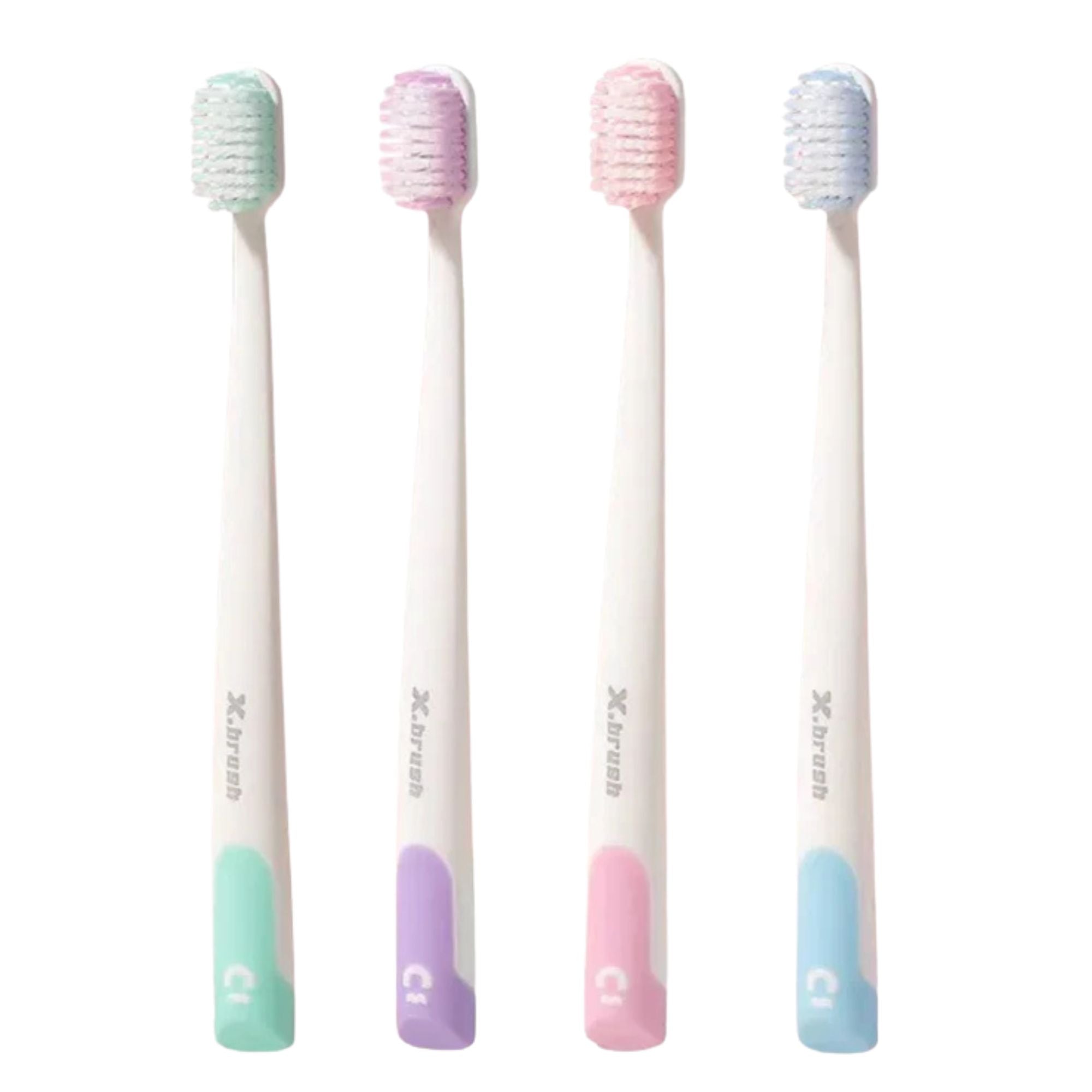 Four pastel-colored toothbrushes with gradient handles on a white background