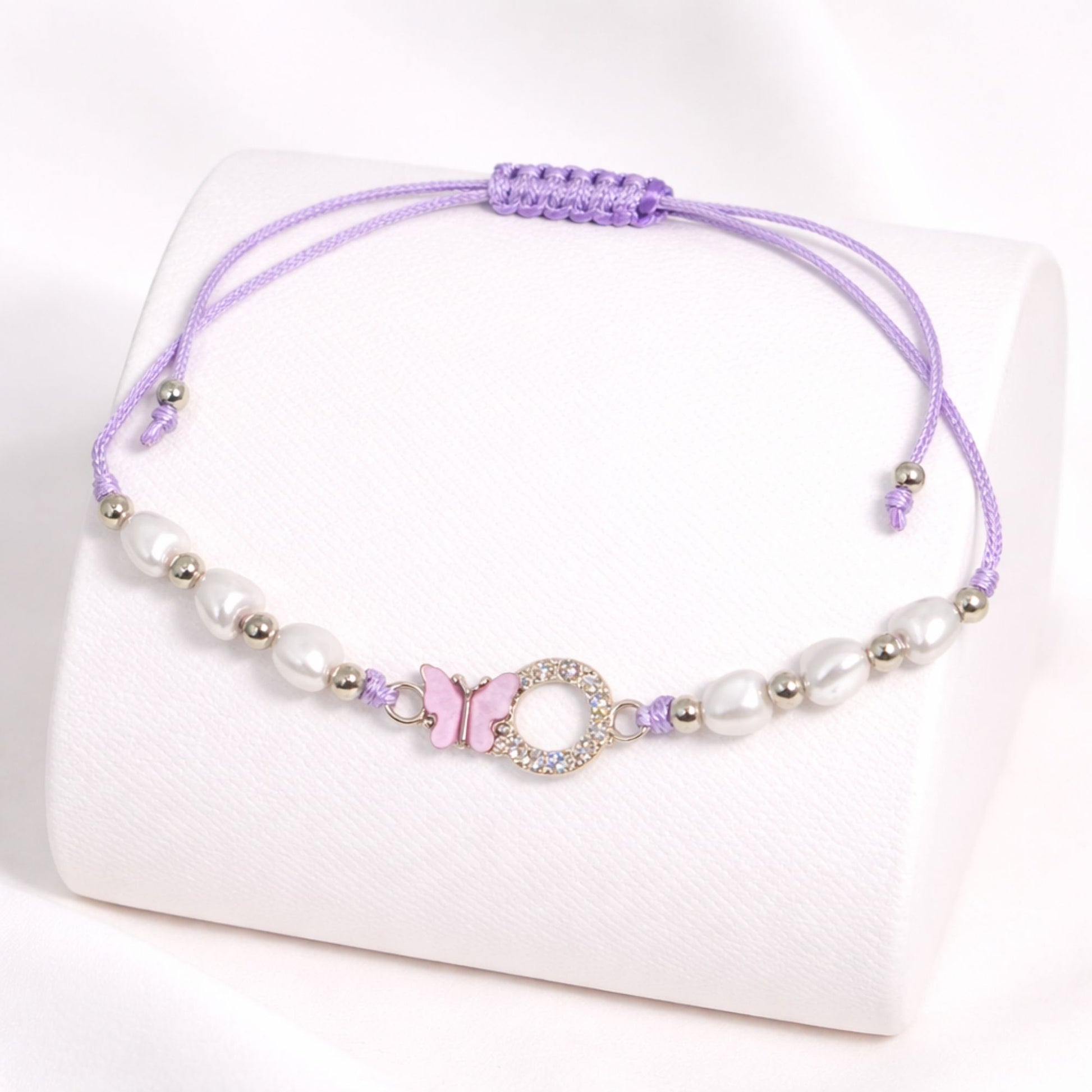 Purple beaded bracelet with a decorative clasp on a white background