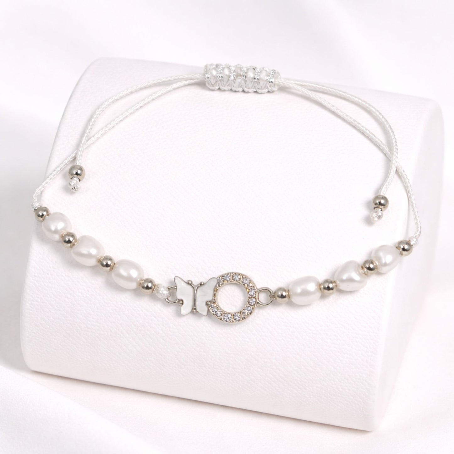 Pearl necklace with silver accents on a white background