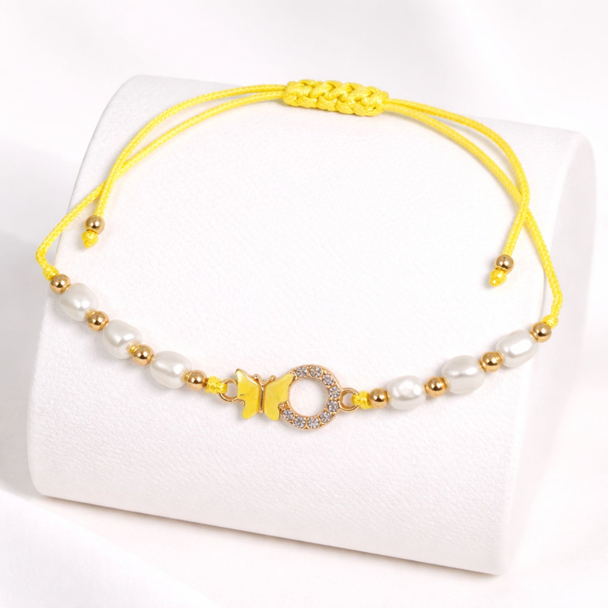 Yellow and white beaded bracelet on a white background