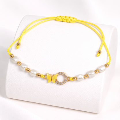 Yellow and white beaded bracelet on a white background