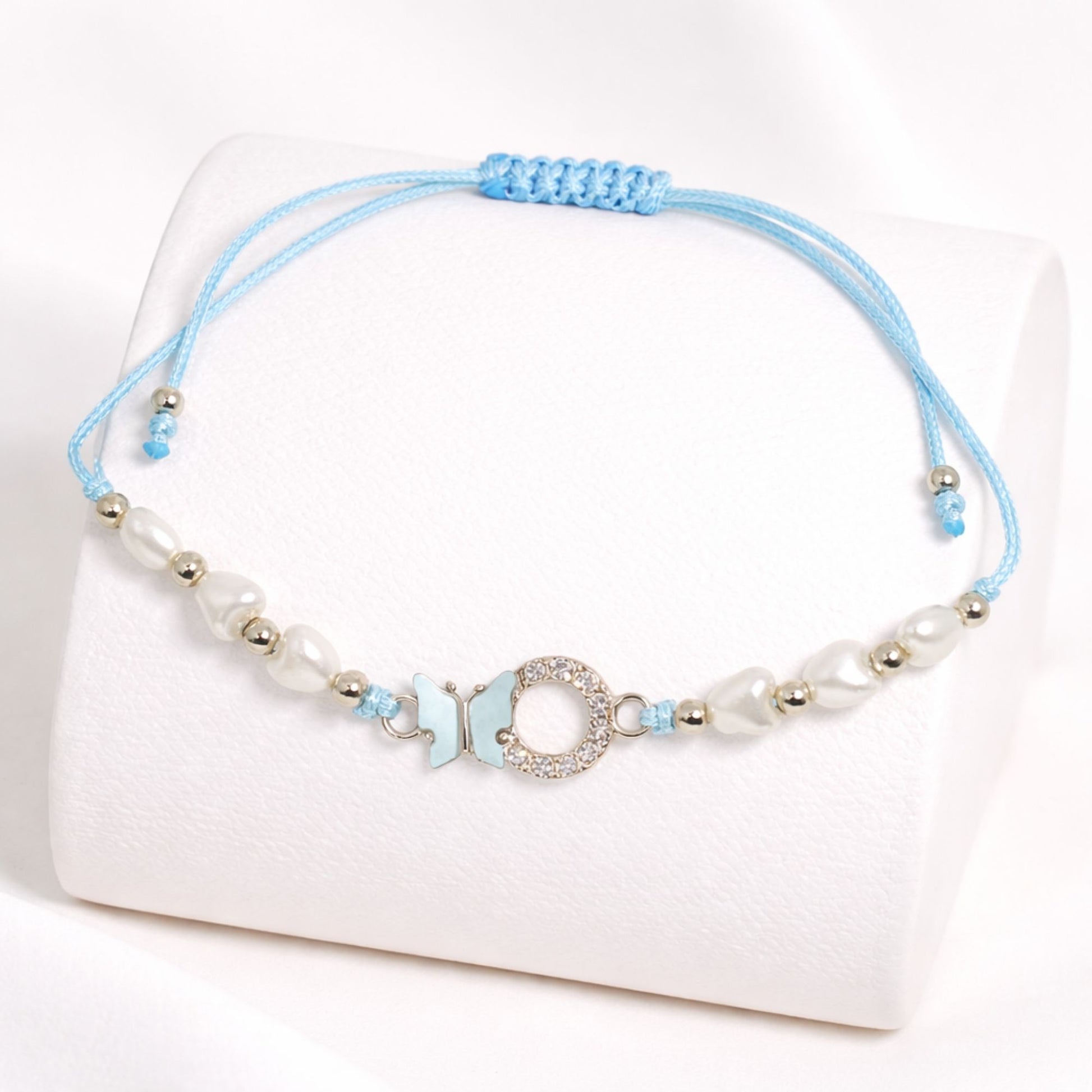 Blue beaded bracelet with a decorative clasp on a white background