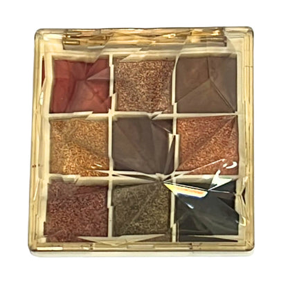 Makeup palette with nine square compartments in a gold case