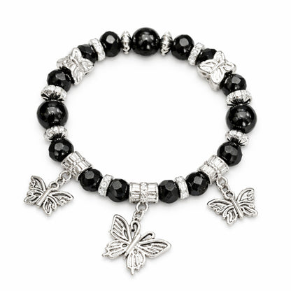 Black beaded bracelet with silver butterfly charms on a white background