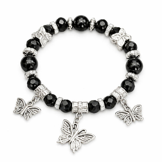 Black beaded bracelet with silver butterfly charms on a white background