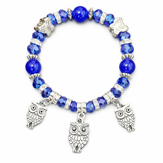 Blue beaded bracelet with owl charms on a white background