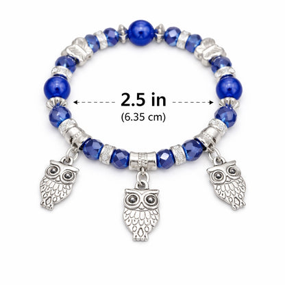 Blue beaded bracelet with owl charms and measurement label on a white background