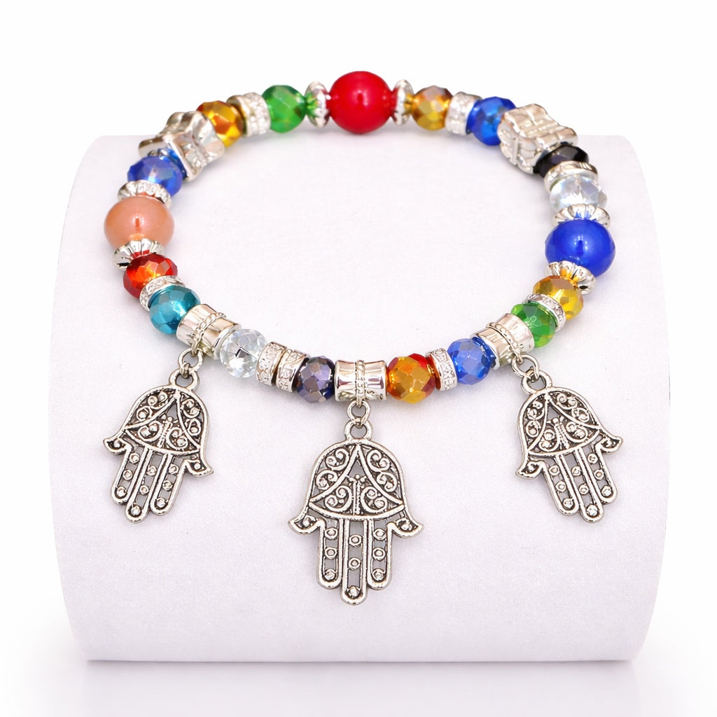 Colorful beaded bracelet with Hamsa hand charms on a white background