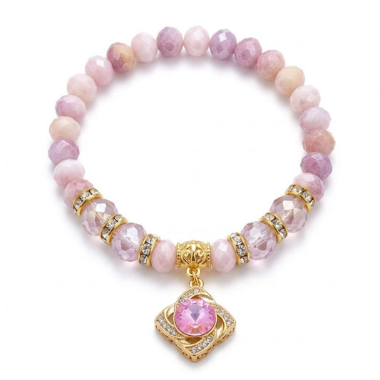 Pink beaded bracelet with a gold charm on a white background