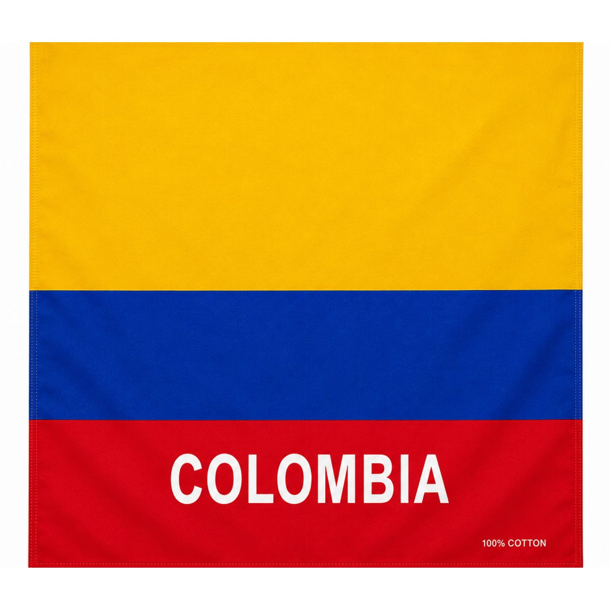 A square cotton flag or towel featuring the horizontal yellow, blue, and red stripes of the Colombian flag, with the word "COLOMBIA" printed in large white letters across the red band and a small "100% COTTON" label in the lower right corner.