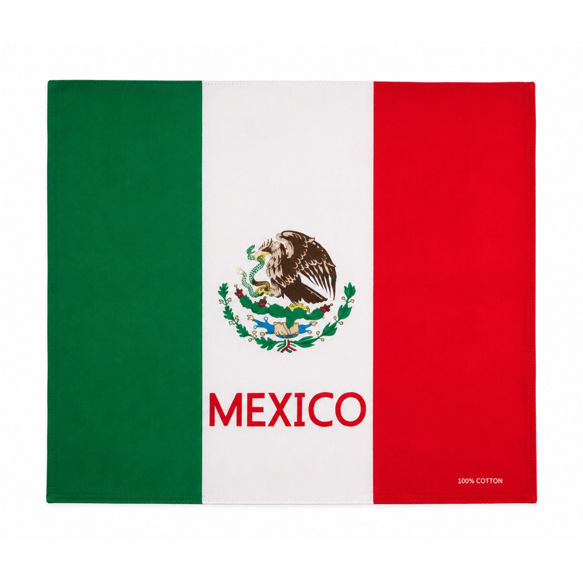 A rectangular Mexican flag placemat featuring the classic green, white, and red vertical stripes with the Mexican coat of arms in the center and the word 'MEXICO' printed in red across the white stripe. A small '100% COTTON' label is visible in the bottom right corner.