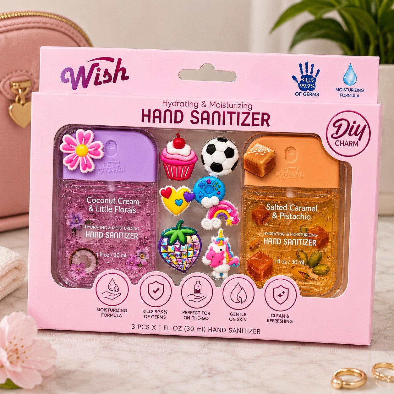 Packaged hand sanitizers with decorative charms on a pink background