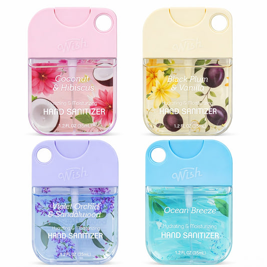 Four small bottles of hand sanitizer with colorful packaging on a white background