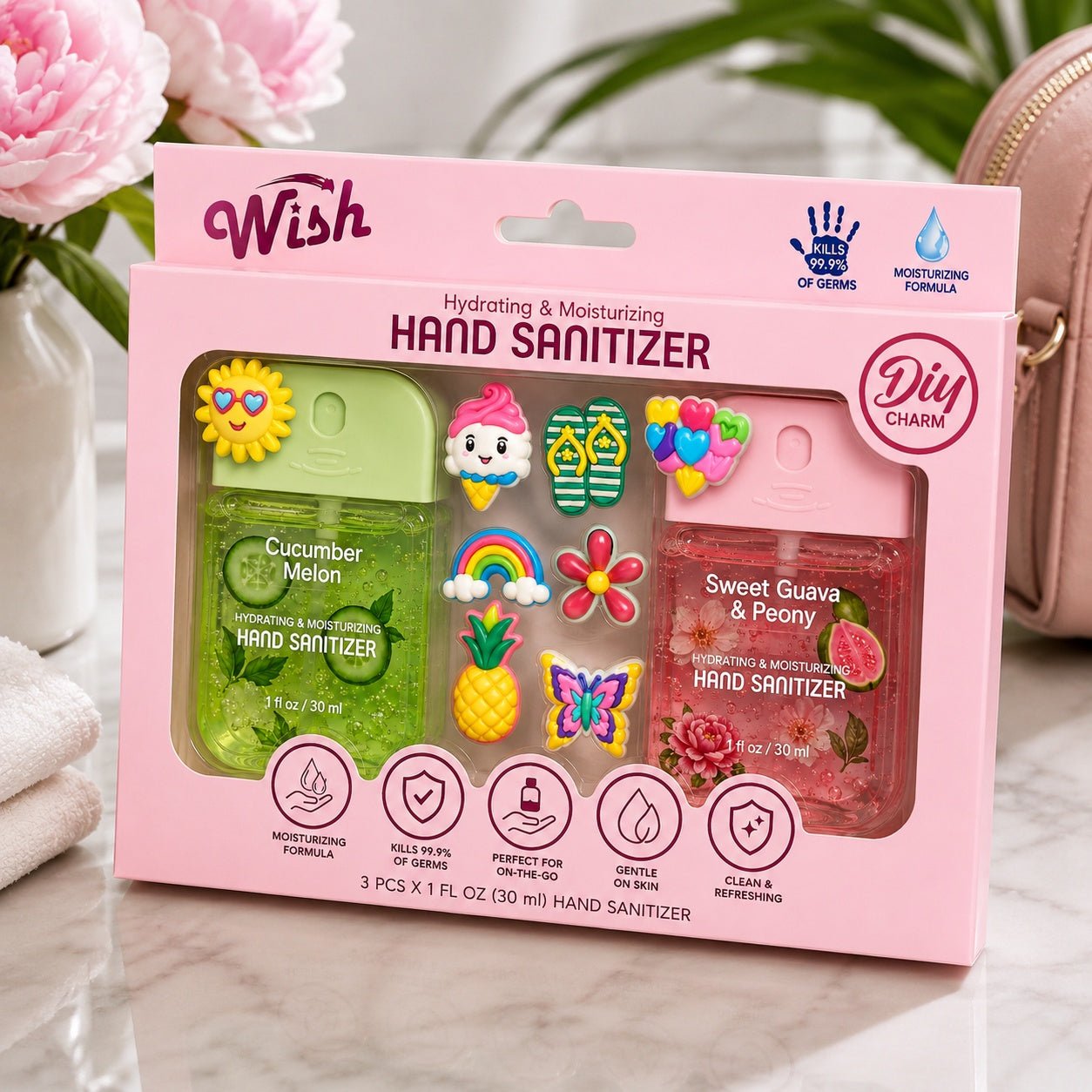 Pink packaging of Wish hand sanitizers with decorative charms on a neutral background