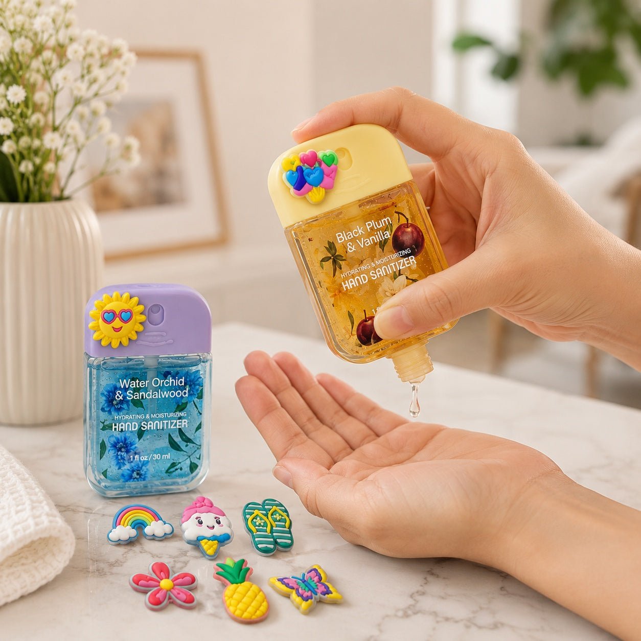 Hand using a yellow hand sanitizer bottle with colorful designs, next to a blue bottle of hand sanitizer on a marble surface.