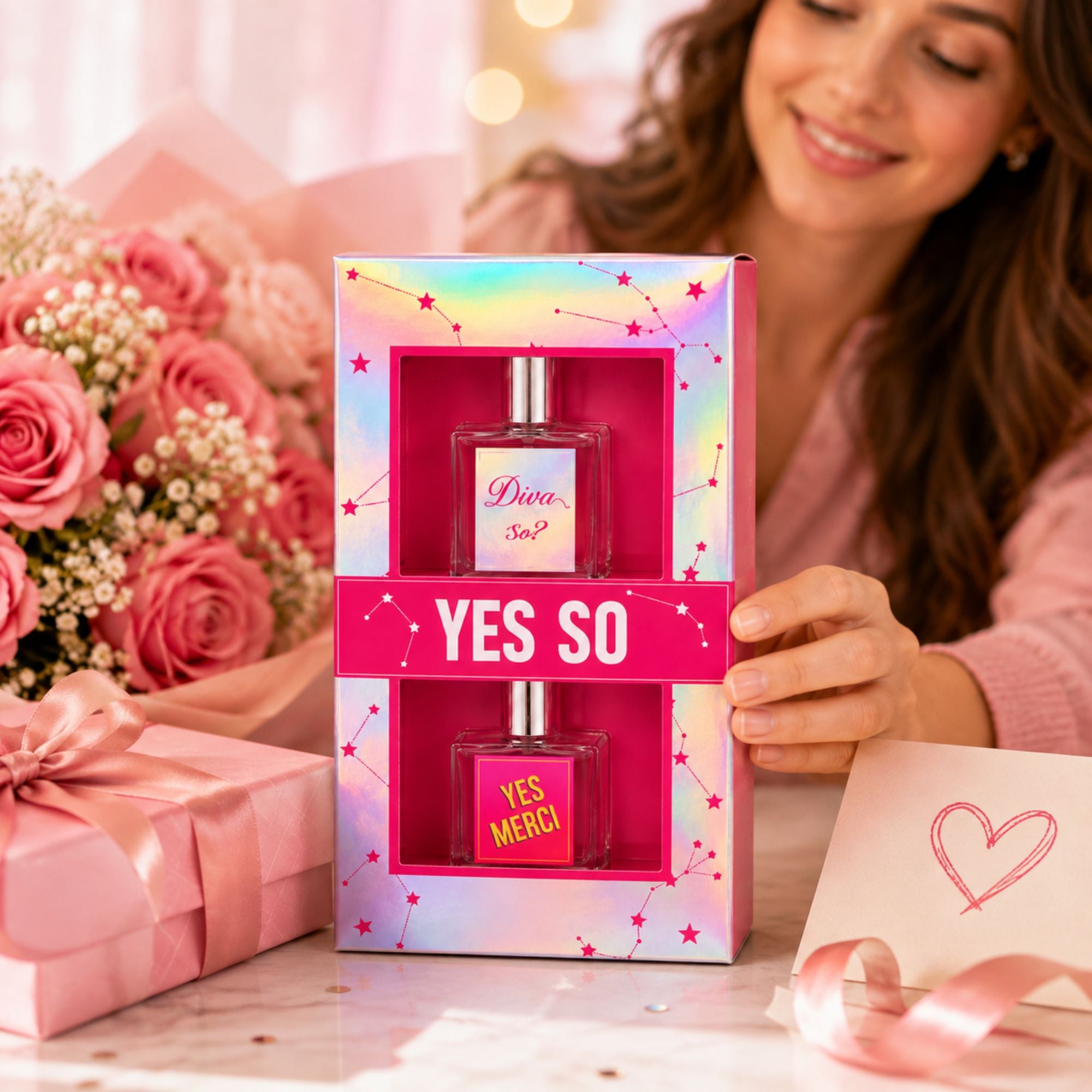 A woman holds a pink and holographic gift box containing two perfume bottles labeled 'Diva Sicily' and 'YES MERCI'. The scene is decorated with pink roses, a pink gift box, and a card with a heart, in a bright, romantic setting.
