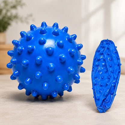 Blue textured ball and leaf-shaped object on a neutral background