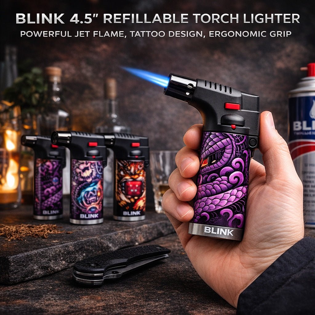 Blink 4.5" refillable torch lighter with tattoo design held by a hand, surrounded by other lighters and a can.