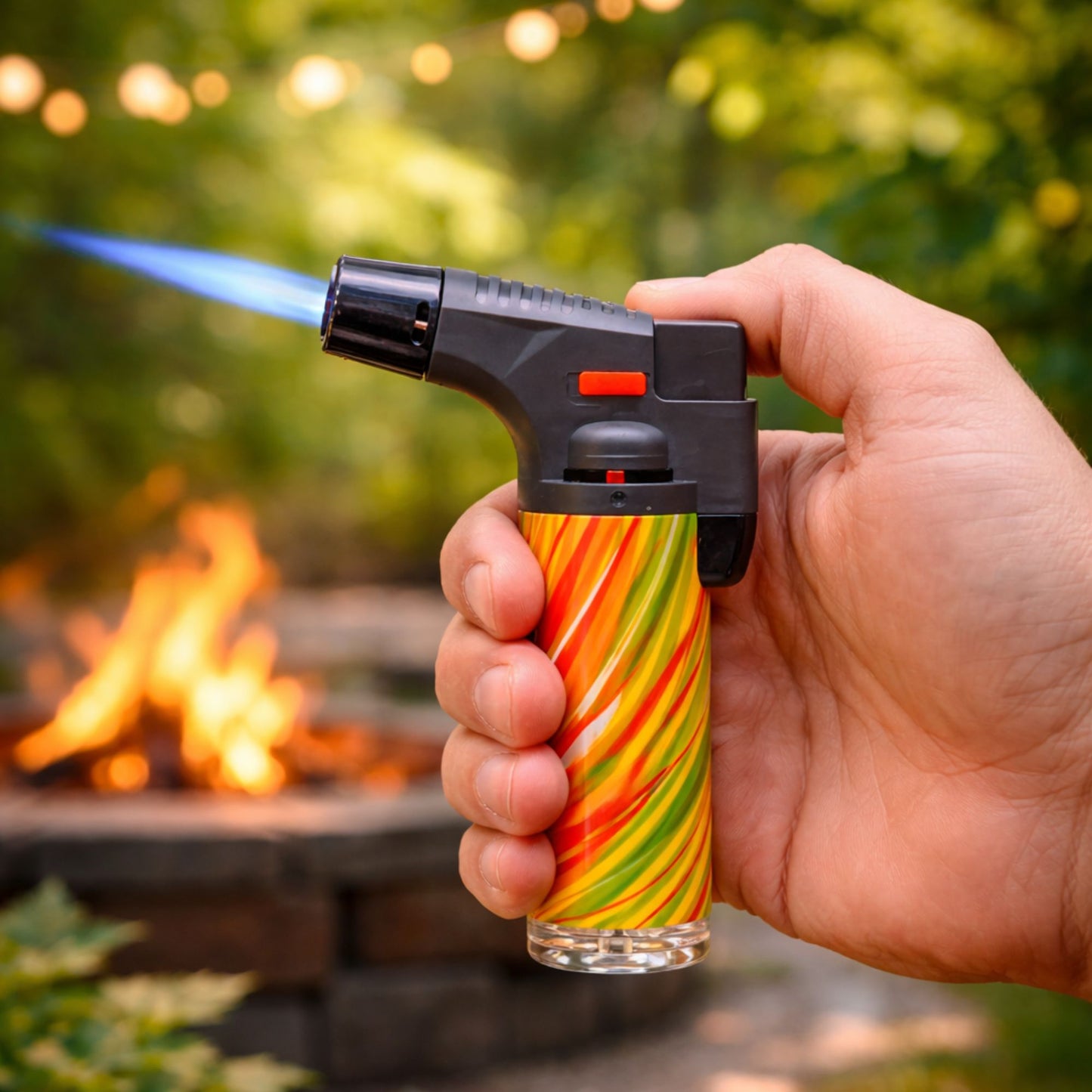 Using Blink 4.5-inch tie dye torch lighter with blue jet flame in front of a fireplace.