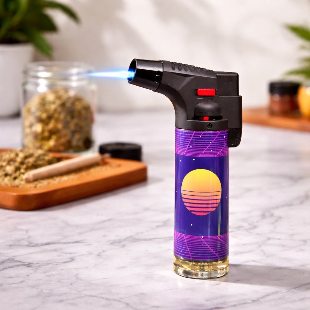 Butane lighter with a colorful design on a marble surface, with plants and jars in the background.