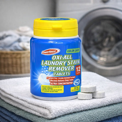 Powerhouse Oxi-All Laundry Stain Remover Tablets container with tablets on a towel in front of a washing machine.