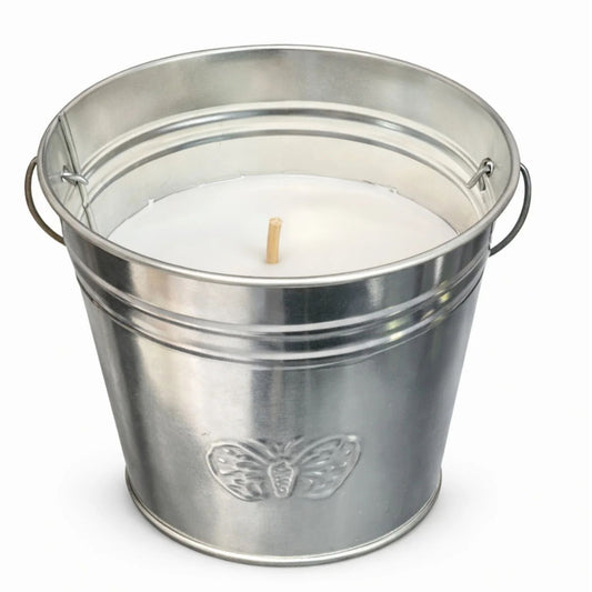 Metal bucket with a white candle inside on a white background