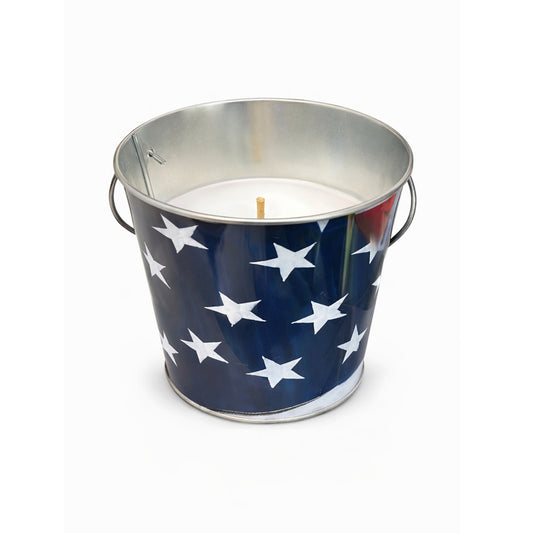 Candle in a metal bucket with American flag design on a white background