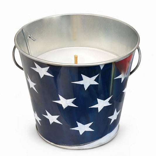 Metal bucket candle with American flag design on a white background