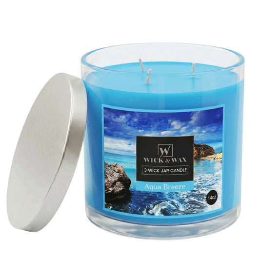 Blue candle in a glass jar with a label featuring an ocean scene, on a white background.
