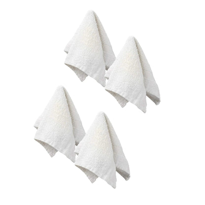 Four white textured towels on a white background
