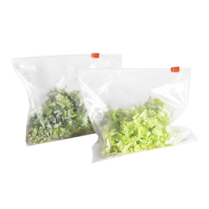 Two clear plastic bags with green contents on a white background