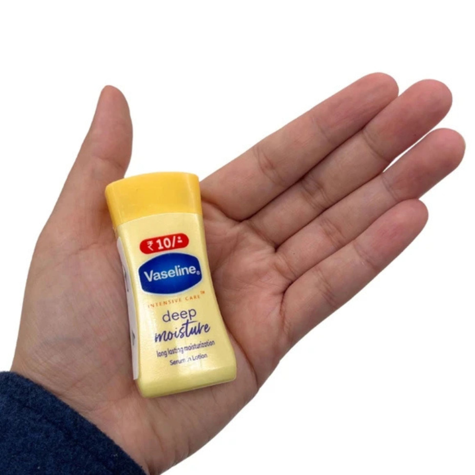 Vaseline deep moisture tube held in a hand on a white background