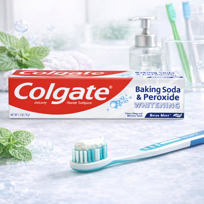 Colgate baking soda and peroxide whitening toothpaste with a toothbrush on a light background