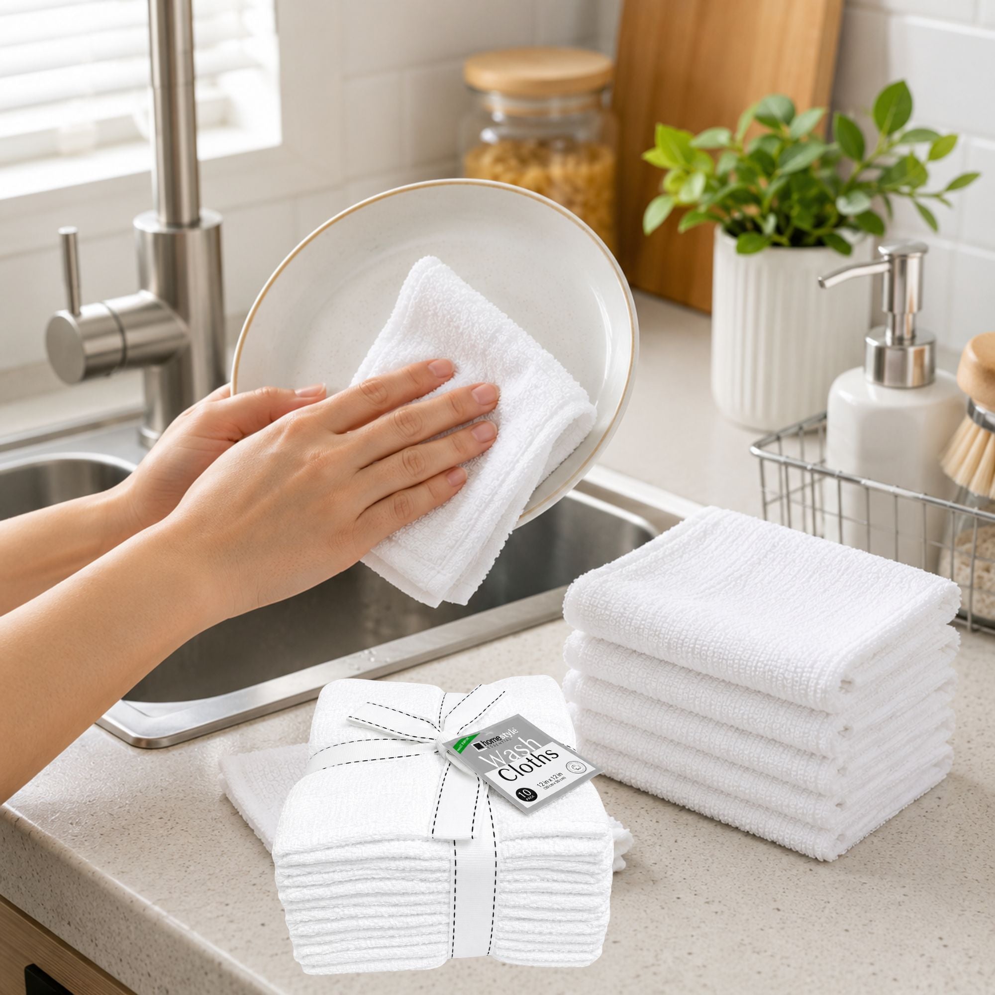 Person cleaning a plate with a white towel in a kitchen, with folded towels and a box of towels on the counter.